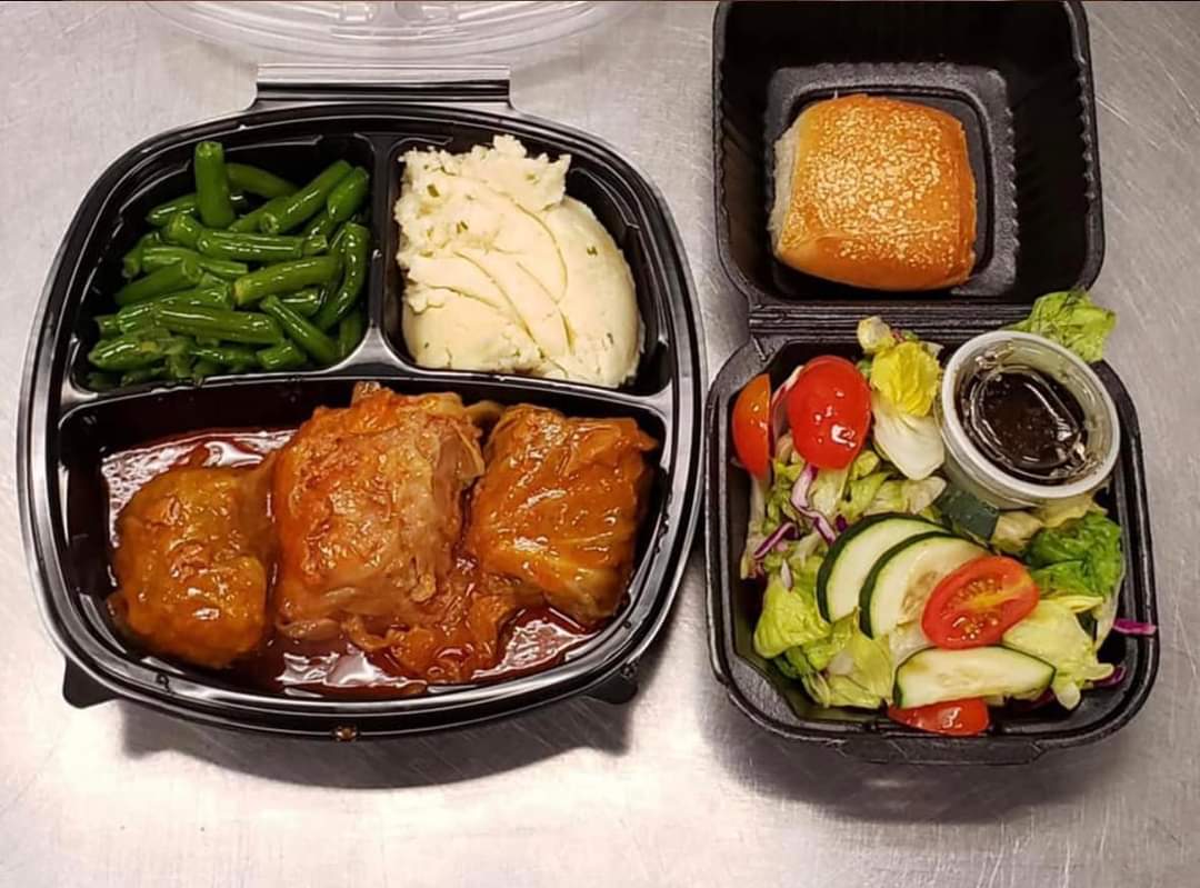 Takeout tray with braised meat and sides