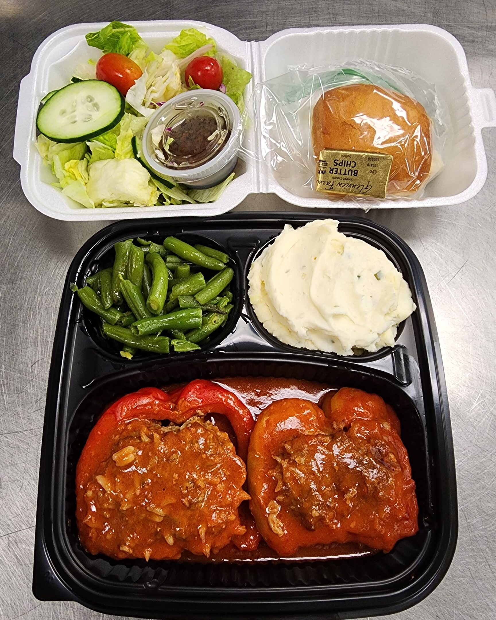 Takeout tray with stuffed peppers and sides
