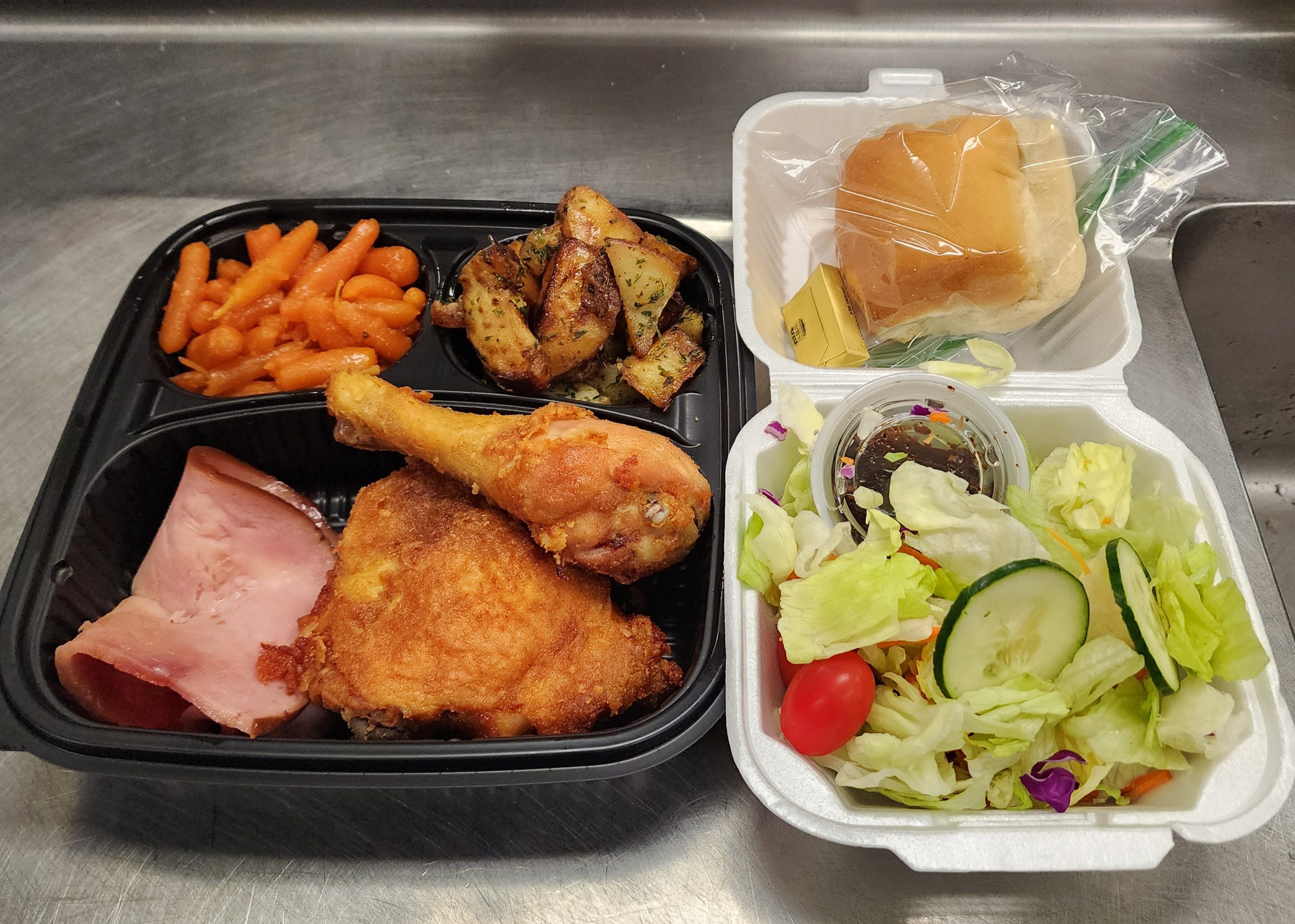 Takeout meal with fried chicken and salad